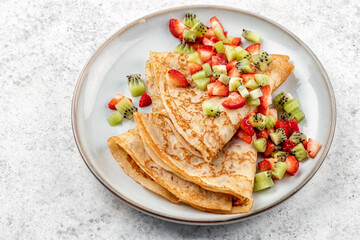 Healthy crepes with fruits kiwi and strawberry. Healthy french breakfast