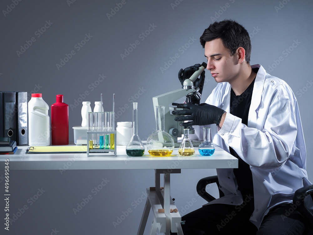 Poster man microscope. laboratory technician during work. test tubes and microscope on scientist table. lab
