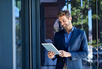 Keeping track of meetings. Shot of a young businessman busy on a digital tablet.