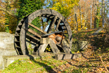 Old dilapidated wooden waterwheel in countryside.
