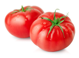 two fresh tomatoes with water drops on a white isolated background