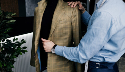 tailor checks the quality of suit.