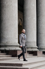  bearded man walking on steps