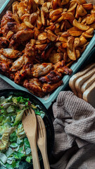 baked potatoes with chicken wings, green salad with bread