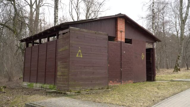 Old-fashioned USSR toilet architectural design sample in a landscaped Vintage environment in outdoors.  A wooden board construction. Welcome back to the Soviet Union in Russia. 