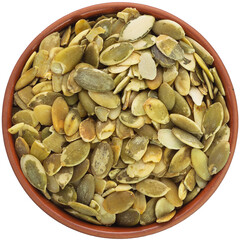 Pumpkin seeds in a brown ceramic bowl. Isolated close-up photo of food close up from above on white background.