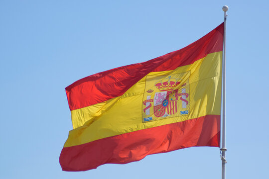 Spain flag waving in the blue sky