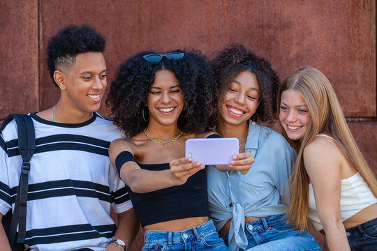 diverse group teens taking selfie with mobil phone