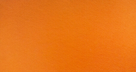 Photo of an orange texture made of felt fabric. Soft orange background for text or lettering....