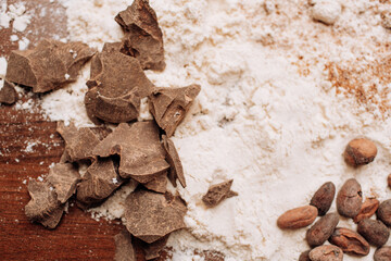 Baking background with ingredients for cake on wood with flour and cocoa