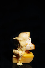 Melted cheese on black background - 496701086