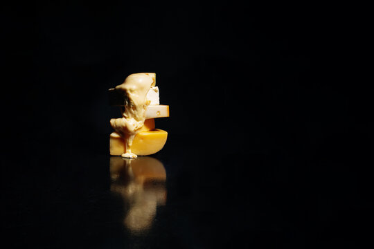 Melted cheese on black background