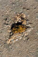 Hole in a rock caused by sea erosion. Concept of wear and tear due to the passage of time.