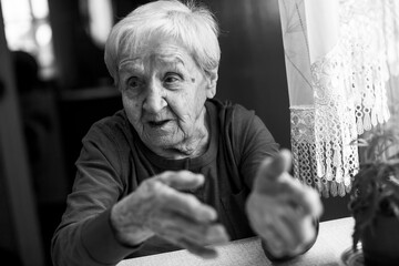 An old woman during a conversation. Black and white photo.