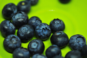 Blueberries on a plate on a white background. Signs. Healthy wholesome food. Vitamins and microelements.