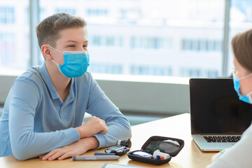 woman doctor pediartic looking at glucometer, checking the blood sugar level, prescribing dose of...