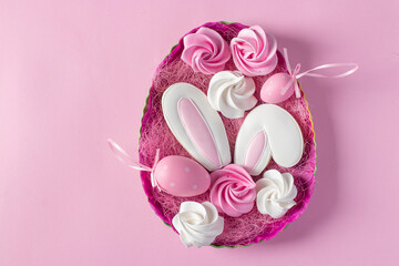 Gingerbread cookies in the form of bunny ears on a pink background. Concept of the spring church holiday