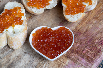natural red salmon caviar with baguette and butter