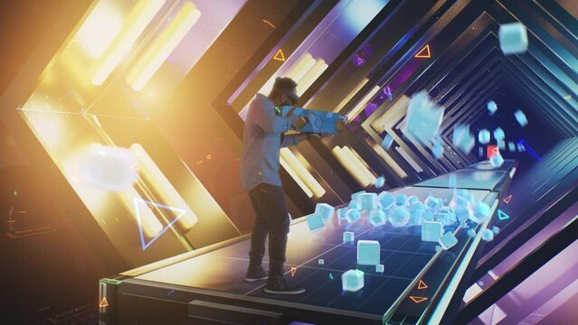 An african american man wearing a virtual reality helmet in the cyberspace of the virtual world plays a video holographic game, by shooting 3D cubes that are thrown at him
