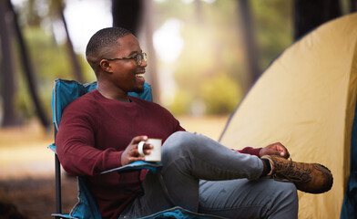 Spending time in nature is the cure for everything. Shot of a man drinking coffee while sitting on a camping chair outside.