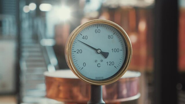 Manometer at background of copper brewery tanks close up.