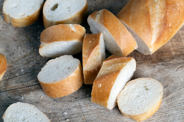 wheat baguette cut into pieces on a cutting board