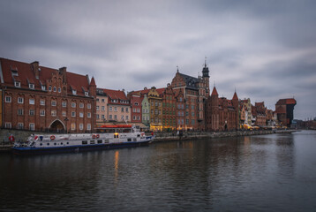 Naklejka na ściany i meble Gdansk old town and famous crane in cloudy day. Gdansk, Poland. November 2021