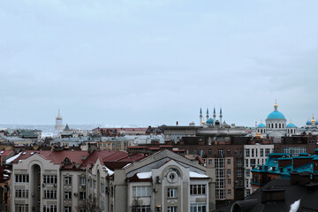 Naklejka premium View from above of the houses of streets in Russian City. Cloudy weather. Selective Focus