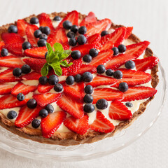 Organic strawberry cake with fresh cream and mint. Festive homemade cheesecake
