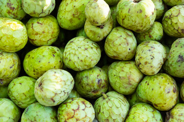 Obraz premium Fresh delicious cherimoya, put up for sale on the counter in the store