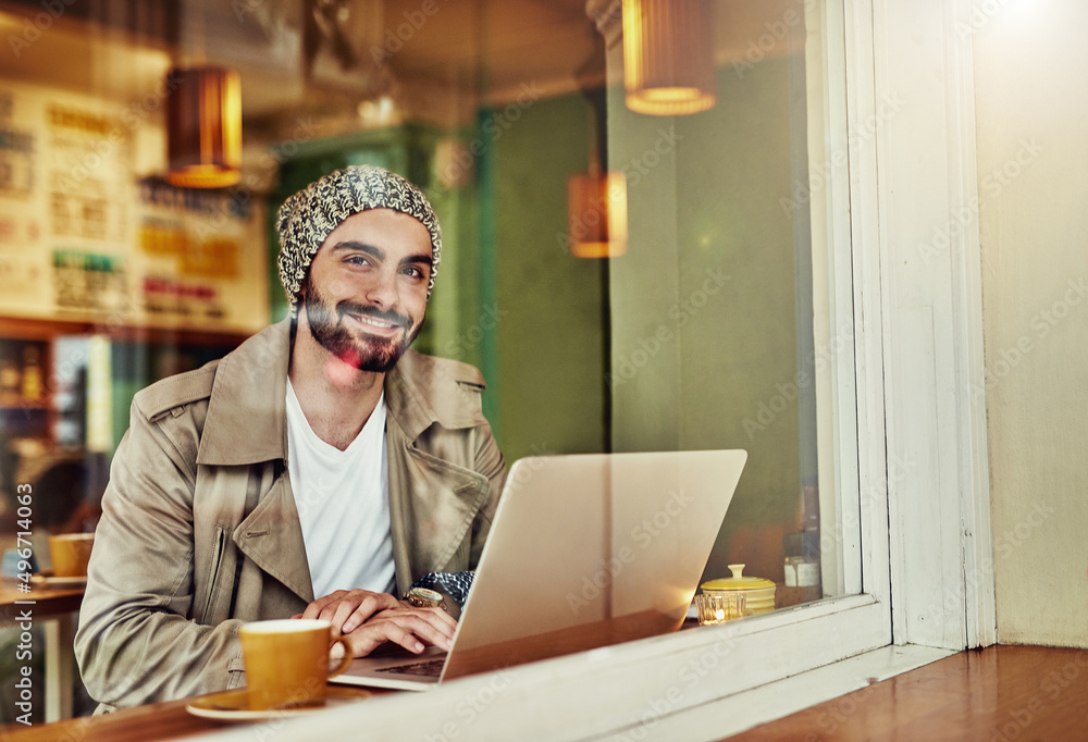 Poster hanging out at his favorite cafe. portrait of a stylish young man smiling while drinking a coffee an