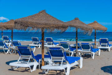 Sunbeds and umbrellas at Playa de Venus at Marbella, Spain.