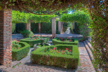 view of a garden of the alcazaba fortress in the spanish city malaga.