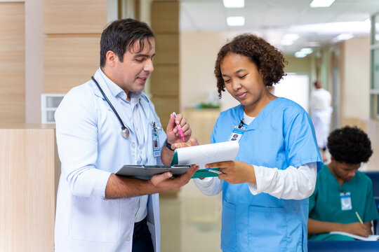 Team Of Diversity Doctor And Nurse Is Discussing And Brainstorming On Patient Medical Record After Diagnosis For Precise Care Plan With Experienced Senior Physician Specialist Concept