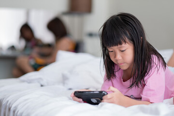 kid is addicted to tablet, little girl playing smartphone, kid use telephone, watching cartoon