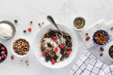 Oat yoghurt bowl with all the toppings including berries, nuts and seeds.