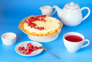 Tea party with vanilla cheesecake. Blue background.