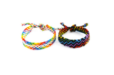 Tied DIY friendship bracelet with unusual braiding pattern on white background