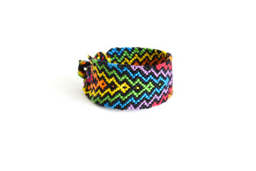 Tied DIY friendship bracelet with unusual braiding pattern on white background