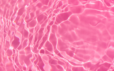de-focused.Closeup of pink transparent clear calm water surface texture with splashes and bubbles. Trendy abstract summer nature background. for a product, advertising, text space
