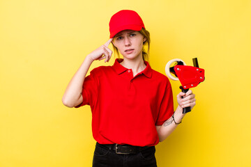 red head pretty woman feeling confused and puzzled, showing you are insane. packer concept