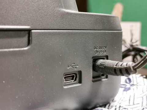 Close up photo of label marker printer power supply connection.