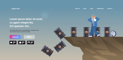 frustrated arab businessman near oil barrels falling down in to deep abyss petrol market fuel price crisis concept © mast3r