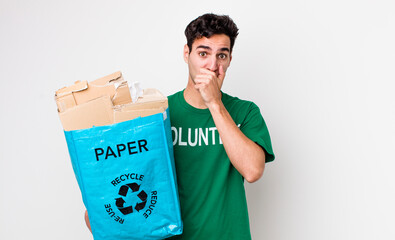 handsome hispanic man covering mouth with hands with a shocked. ecology concept