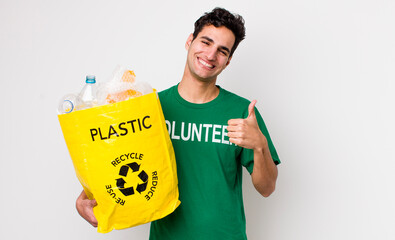 handsome hispanic man feeling proud,smiling positively with thumbs up. ecology concept
