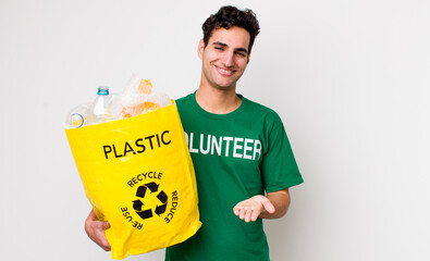 handsome hispanic man smiling happily with friendly and  offering and showing a concept. ecology...