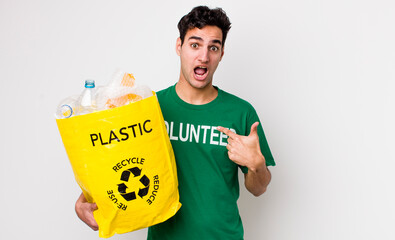 handsome hispanic man feeling happy and pointing to self with an excited. ecology concept
