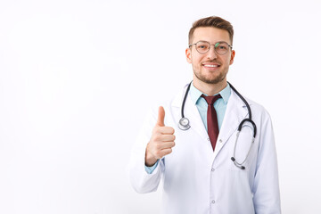 Portrait of confident young medical doctor on white background. The doctor shows the ok symbol