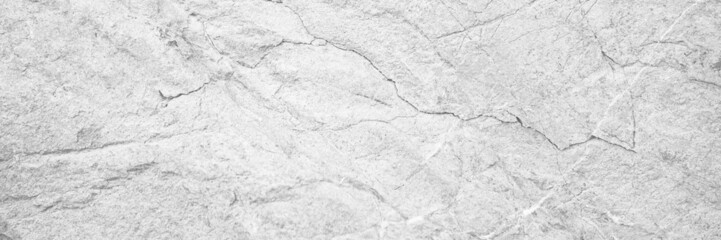 White rock texture. Light gray stone wall background with space for design. Cracked surface. Close-up. Web banner. 