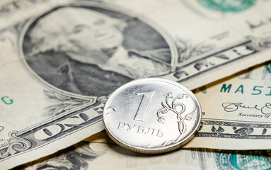 Russian rouble coin on banknotes of United States dollars, financial, money, currency